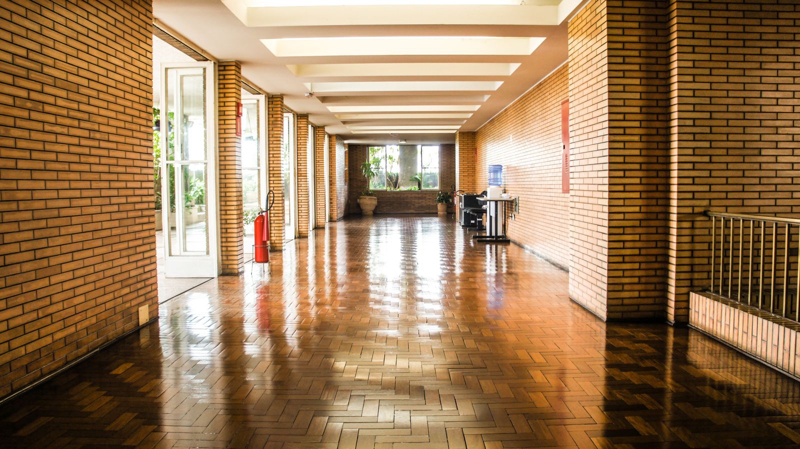 Polished floor running the length of a brick corridor
